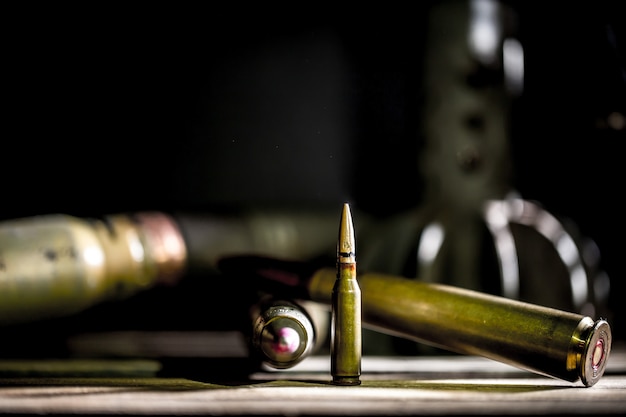 weapons, cartridge on wooden background