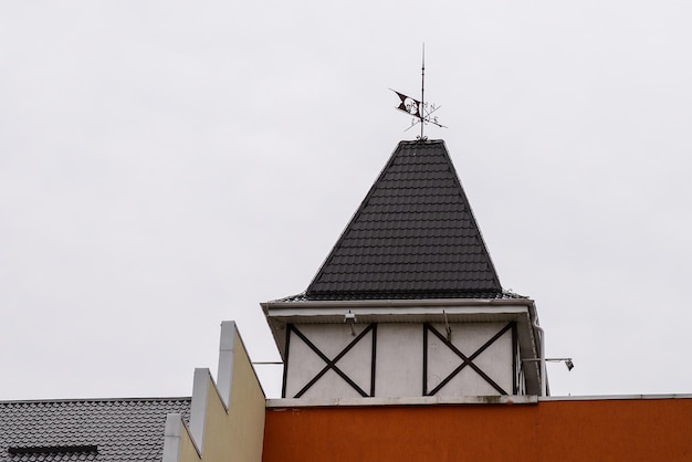 Photo weather vane on the building of german colored architecture