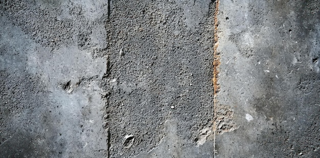 Weathered Concrete Wall with a Vertical Crack and Rust Stain