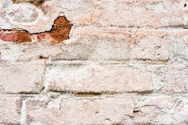 Weathered texture of stained old orange and white brick wall background