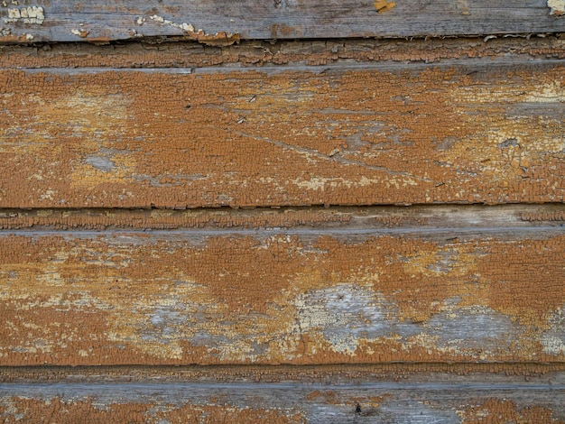 Weathered wooden background peeling paint nailed boarded fence