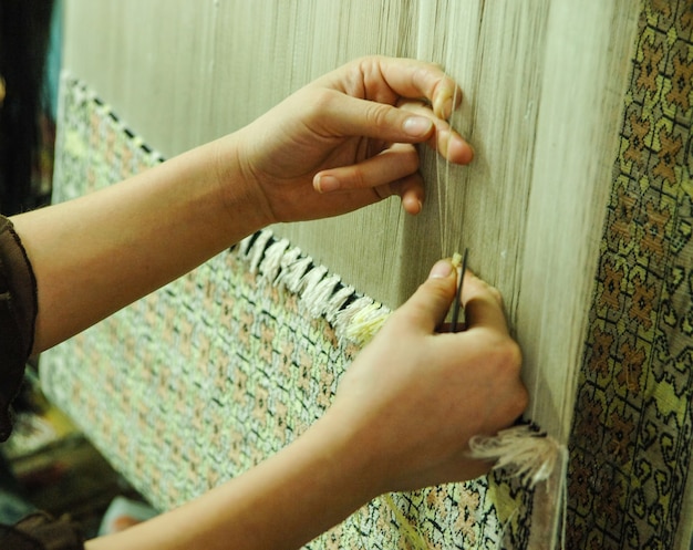 Photo weaving and manufacturing of handmade carpets closeup