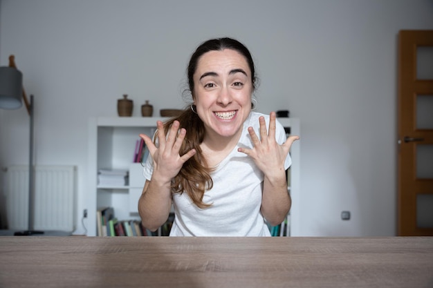 Photo webcam view of excited and enthusiastic woman in a video call