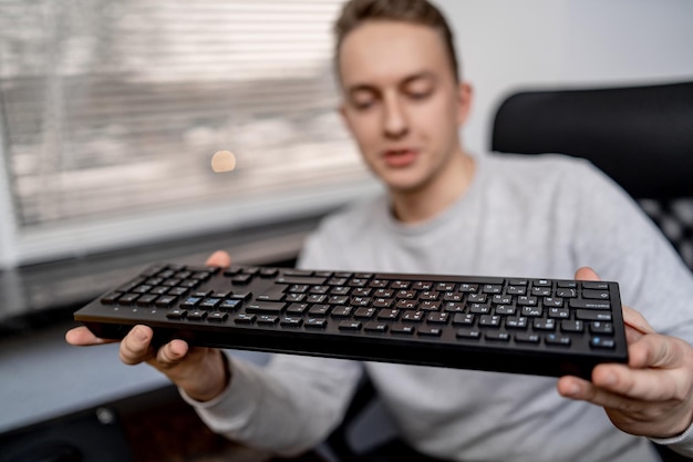 Website design programming and coding technologies. Man sitting at his workplace and holding computer keyboard