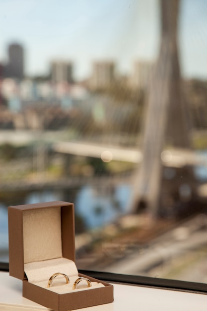 wedding band with a blurred cable-stayed bridge in Sao Paulo, Brazil.