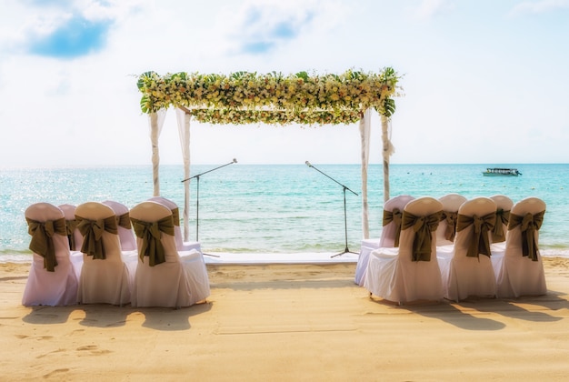 Wedding on the beach . Wedding arch decorated of flowers on tropical sand beach.