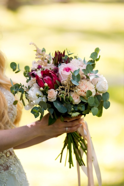 Wedding bouqet in woman hands Beautiful green floral bouqet