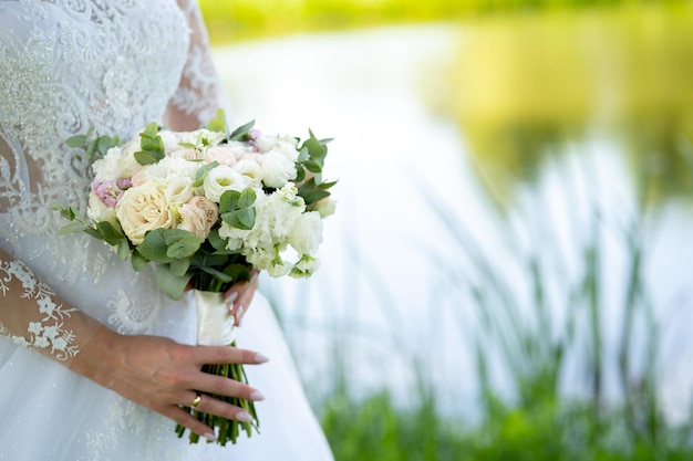 Wedding bouquet of the bride in the hands