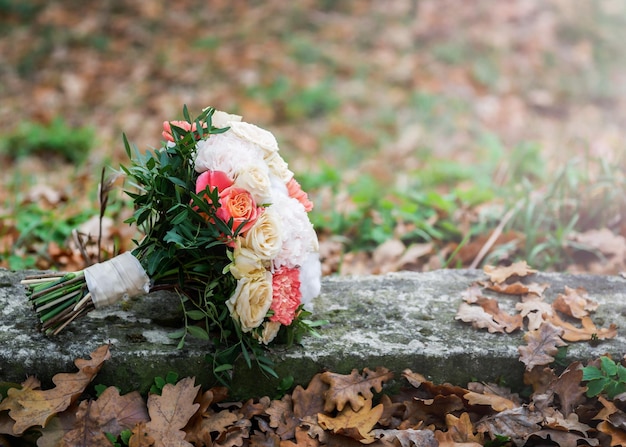 Wedding bouquet of different flowers lying on the ground