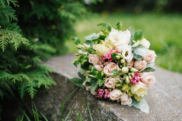 Wedding bouquet of flowers on the old stone