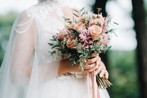 Wedding bouquet in the hands of the bride