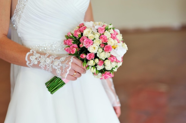 Wedding bouquet in hands of the bride