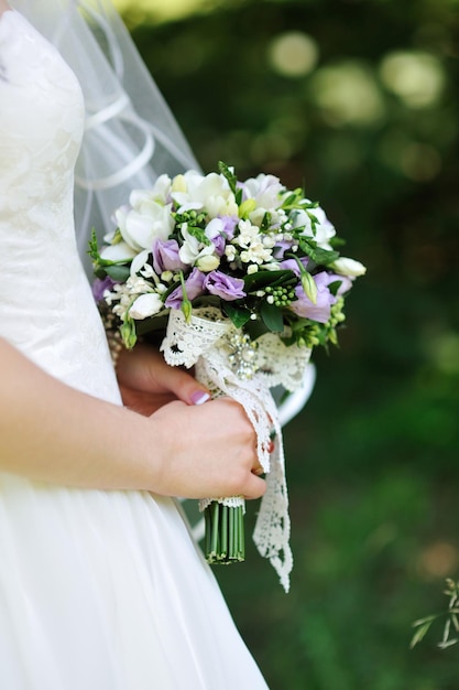 Wedding bouquet in hands of the bride