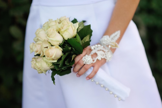 Wedding bouquet in hands of the bride