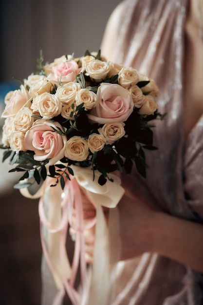 Wedding bouquet in the hands of the bride