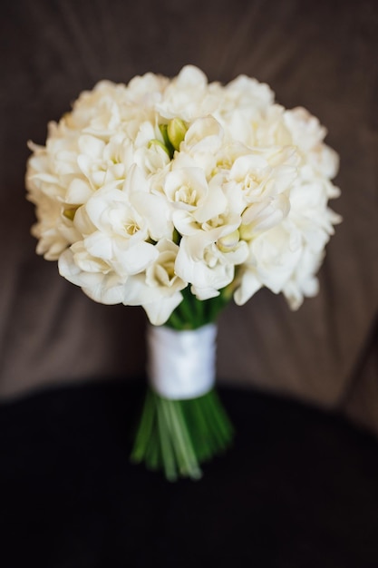 Wedding bouquet of peonies lying on the chair