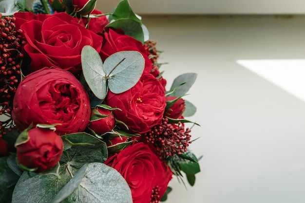 A wedding bouquet of red roses lies 