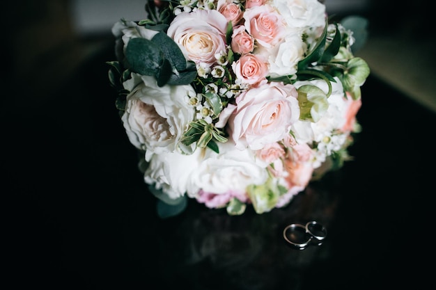 Wedding bouquet of white and pink flowers and wedding ringsx9