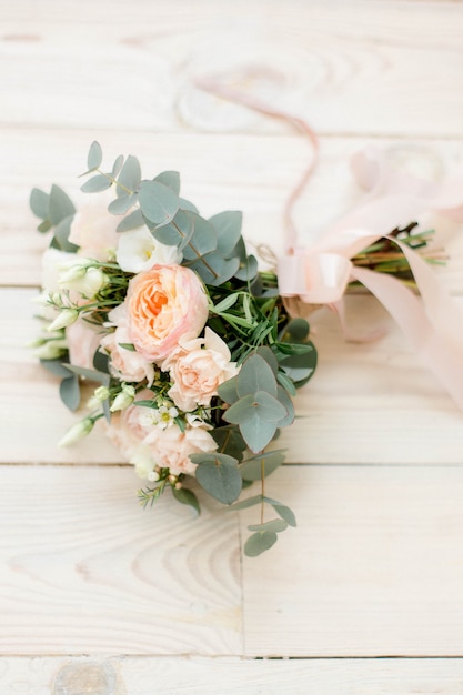 Wedding bouquet with eucaliptus on wooden surface