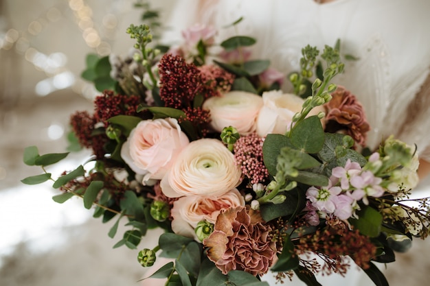 Wedding bouquet with powdery-pink peonies and roses