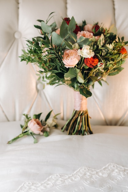 Wedding bouquet with roses and boutonniere