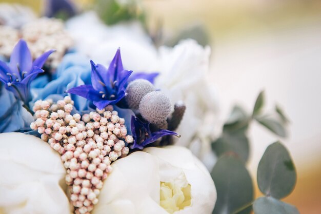 Wedding bouquet with white carnations, blue hyacinths and hydrangea. delicate bouquet in white-blue colors. eucalyptus leaves.