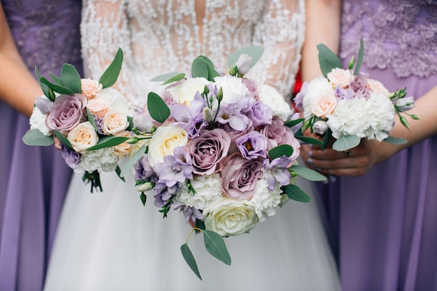 Wedding bouquets in the hands of the bride and bridesmaids