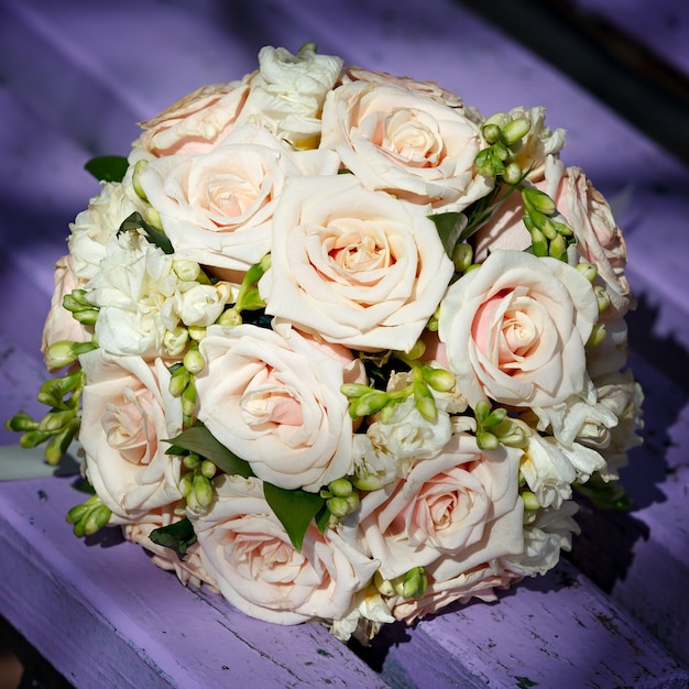 Wedding bridal bouquet lying on a park bench.