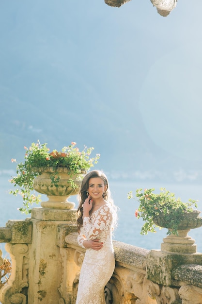 Wedding Bride with veil and white wedding dress on villa Balbianello lake Como in Italy