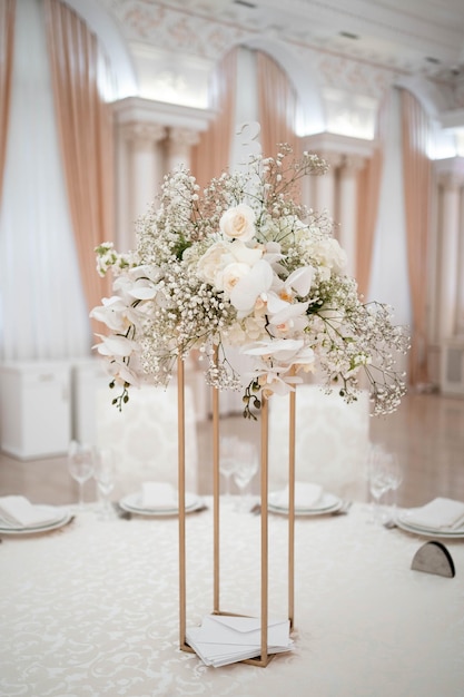 Wedding centerpieces with metal vase and white fresh flowers arrangements