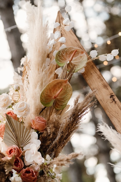 Wedding ceremony area with dried flowers in a meadow in a pine brown forest