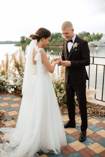 Wedding ceremony on a high pier near the river