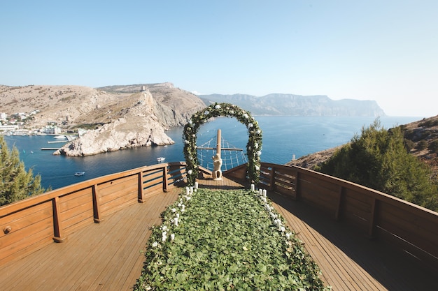 Wedding ceremony in nature near the water and mountains