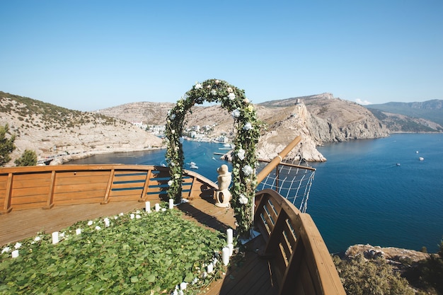 Wedding ceremony in nature near the water and mountains