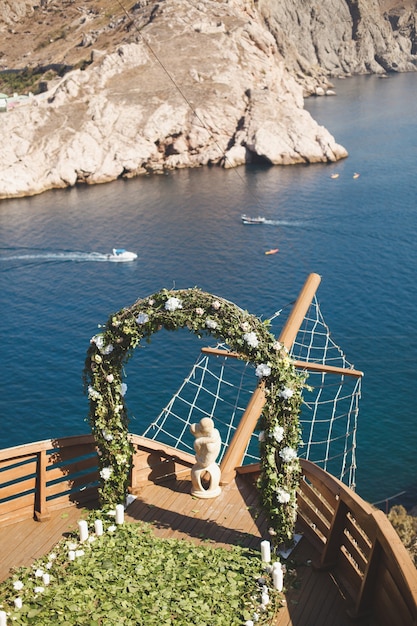 Wedding ceremony in nature near the water and mountains