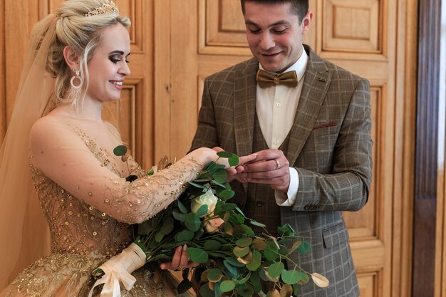 A Wedding ceremony. Registry office. A newly-married couple signs the marriage document.Young couple signing wedding documents.