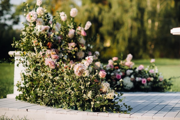 Wedding ceremony on the street on the green lawnDecor with fresh flowers arches for the ceremony