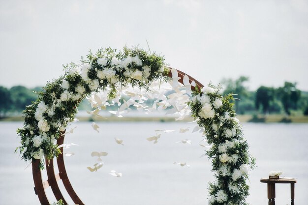 Wedding ceremony on the street on the green lawnDecor with fresh flowers arches for the ceremony