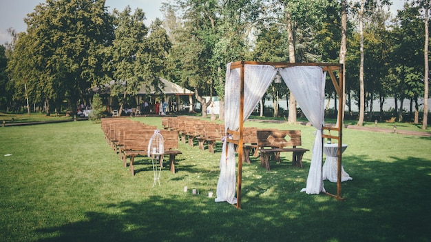 Wedding concept with a wedding arch located on a green lawn