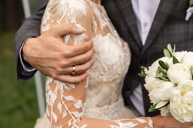 Wedding couple, bride and groom holding hands, beautiful wedding day