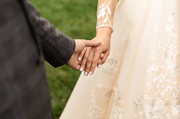 Wedding couple, bride and groom holding hands