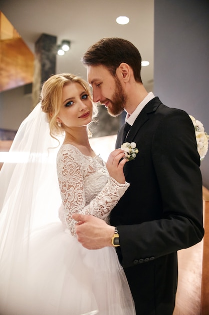 Wedding couple hugging and kissing, the first day of life together. Bride and groom after wedding ceremony, beautiful couple loves each other and hugging