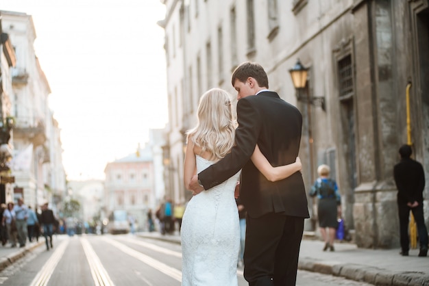 Wedding couple is walking on tram ways