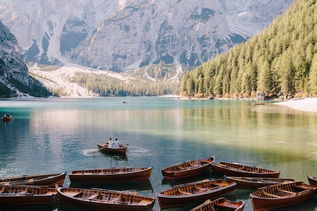 Wedding couple sailing in a wooden boat at the Lago di Braies in Italy