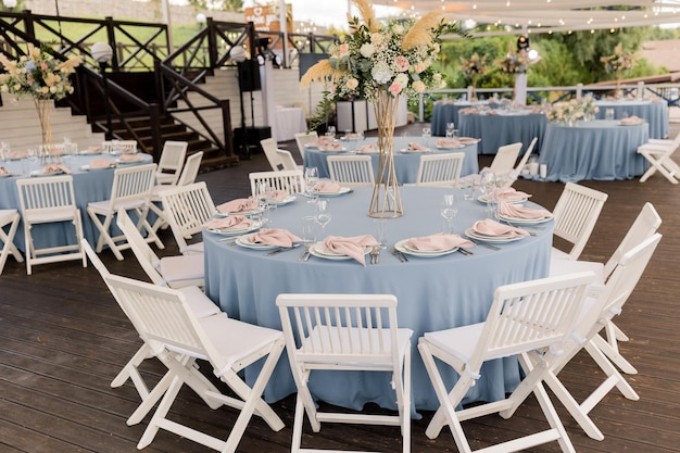 Wedding decor in delicate blue with pink napkin table setting with white beautiful flowers