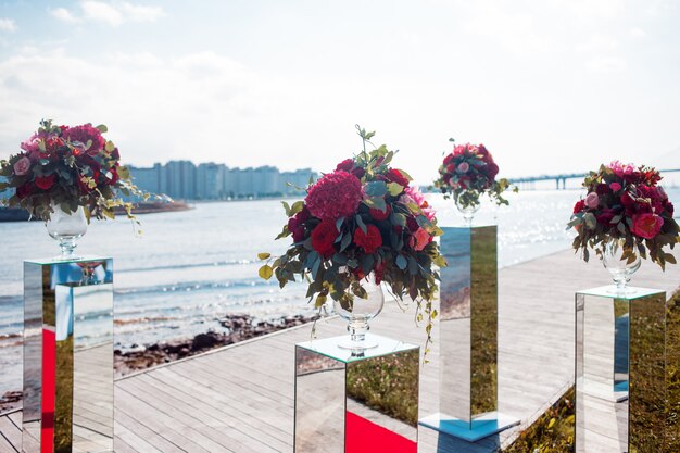 Wedding decor. Wedding registration outdoor. Luxury bouquets with red flowers