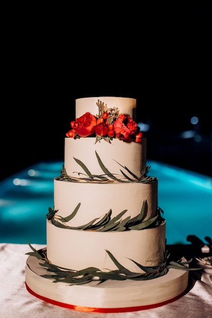 Wedding decor with cake on a wooden bench against a waterfall background