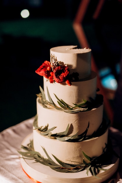 Wedding decor with cake on a wooden bench against a waterfall background