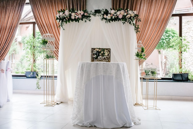 Wedding decorations in luxury ceremony Arch for wedding ceremony a is decorated with flowers and greens greenery wedding decor in the banquet hall