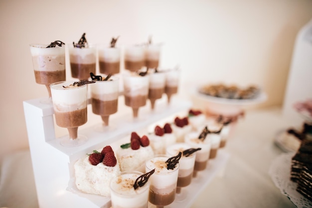 Wedding desserts cakes candies on the dessert table at the wedding ceremony